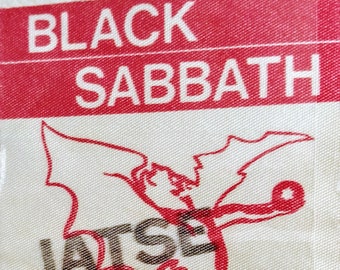 May include: Red and white fabric patch with the text "BLACK SABBATH" and a red illustration of a winged demon with the text "VATSE" in brown. The bottom of the patch has the text "ALL-AMERICA 80" in red.