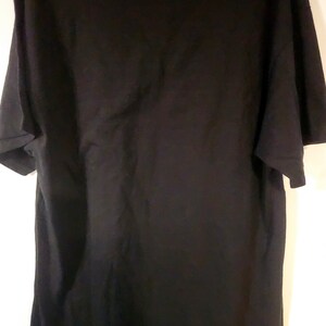 May include: A black short-sleeved t-shirt. The shirt is plain with no visible graphics or text.