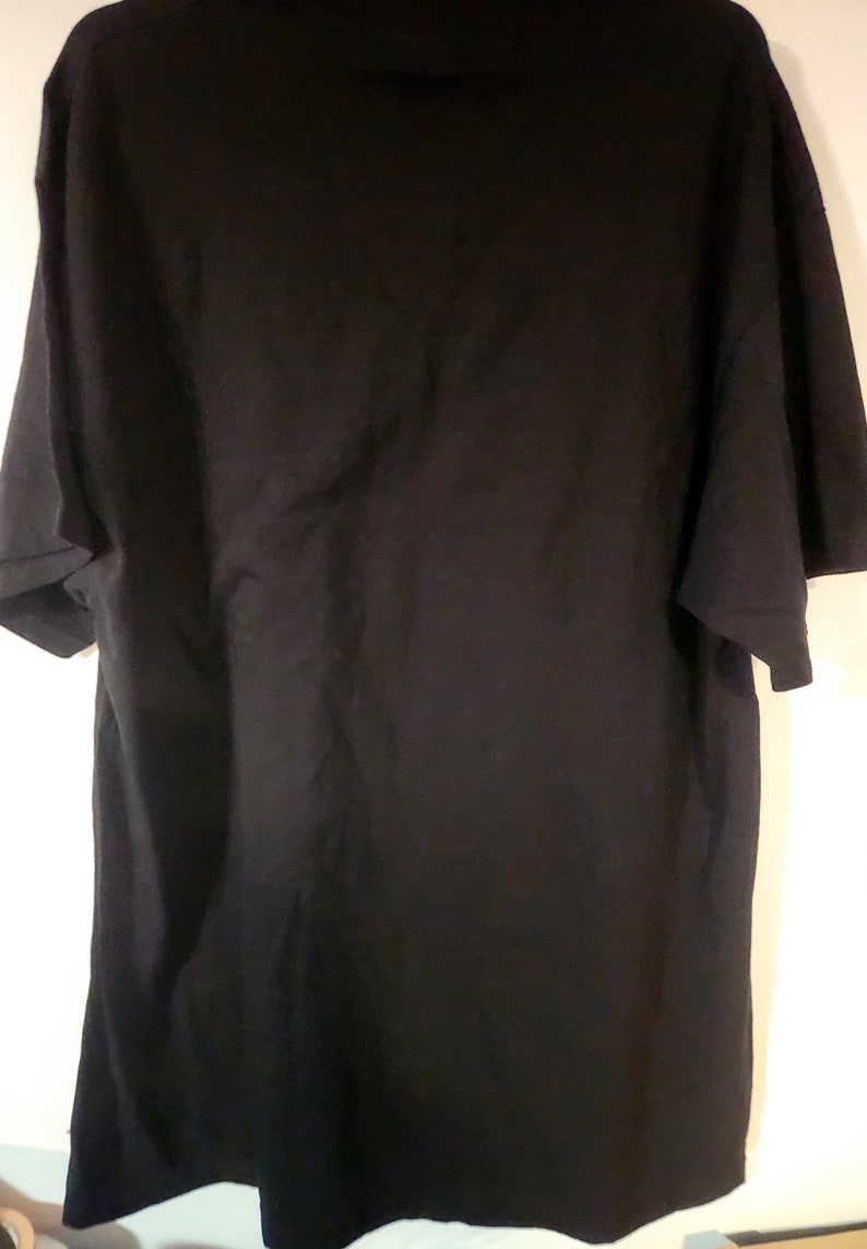 May include: A black short-sleeved t-shirt. The shirt is plain with no visible graphics or text.