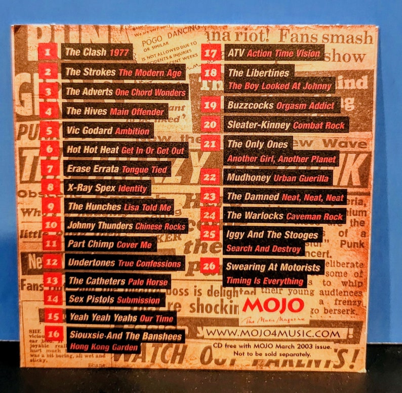May include: A close-up of a CD featuring a list of punk rock bands from the 1970s and 1980s. The CD is a free gift with the March 2003 issue of MOJO magazine. The text on the CD reads "Not to be sold separately."