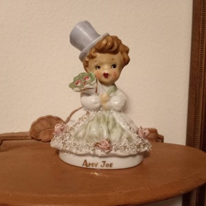 Amy Joe spaghetti trim girl figurine holding bouquet of flowers