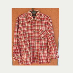 May include: A red, white, and yellow plaid button-down shirt with a chest pocket. The shirt has long sleeves and a collar. The tag reads "PERFECT SHIRT".