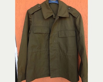 May include: Olive green military-style jacket with two chest pockets and shoulder epaulets. The jacket has a button-down front and a classic collar. A vintage-inspired garment, suitable for casual wear.