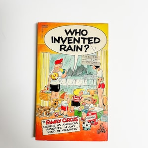 May include: A comic book cover featuring a cartoon family in a rainy scene. The cover is yellow and orange with the title "Who Invented Rain?" and the text "The Family Circus reigns as America's favorite in any kind of weather!"