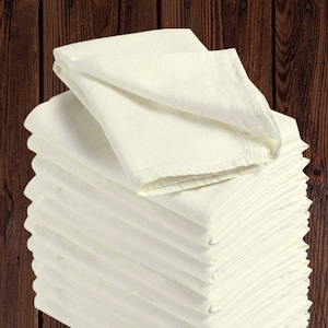 May include: A stack of 10 white cotton dish towels folded neatly. The towels are soft and absorbent, perfect for drying dishes, wiping spills, and cleaning surfaces.