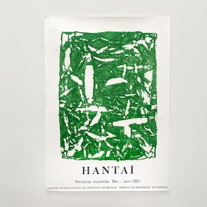 May include: A vintage art poster featuring a green abstract design with white accents. The poster includes the name "HANTAÏ" and text in French, indicating a 1981 exhibition at the Centre International de Création Artistique.