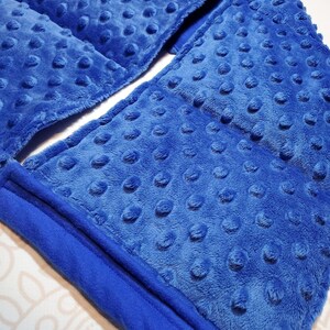 May include: A blue weighted blanket with a soft, textured surface. The blanket is folded in half and has a seam down the center.