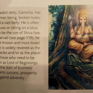 May include: A colourful painting depicting Ganesha, the elephant-headed Hindu deity. He is seated with a large belly, holding a small axe and a bowl. He is surrounded by lush green foliage.