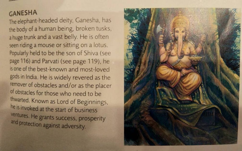 May include: A colourful painting depicting Ganesha, the elephant-headed Hindu deity. He is seated with a large belly, holding a small axe and a bowl. He is surrounded by lush green foliage.