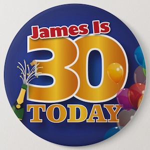 May include: A blue round button with the text "James is 30 TODAY" in gold lettering. The number 30 is large and in the centre of the button. There is a champagne bottle with a cork popping and a scattering of gold stars. There are also colourful balloons in the background.