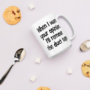 May include: White ceramic coffee mug with black text that reads "When I want your opinion, I'll remove the duct tape".