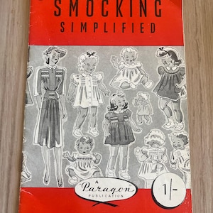 May include: Vintage "Smocking Simplified" booklet with a red cover and illustrations of children's clothing. The cover features the text "SMOCKING SIMPLIFIED" and "A Paragon Publication". The booklet includes the text "Concise, Easy-To-Understand Directions. Fully Illustrated."
