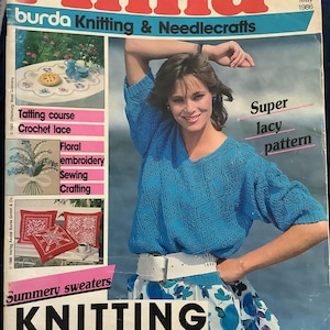 May include: A vintage magazine cover titled "Anna burda Knitting & Needlecrafts" from May 1986. The cover features a woman wearing a blue knitted sweater and a floral skirt. Text includes "Summery sweaters" and "KNITTING".
