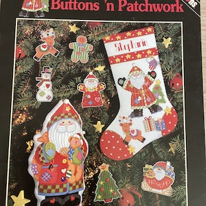 May include: A cross-stitch pattern for a Christmas stocking with the name "Stephanie" on it. The stocking is decorated with a Santa Claus, a reindeer, and a Christmas tree. The pattern is from the "Buttons 'n Patchwork" collection by Sue Dreamer.