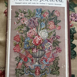 May include: A vintage tapestry firescreen kit from Woman's Journal. The kit features a floral design with birds, a vase, and text that reads "EXCLUSIVE TO READERS OF WOMAN'S JOURNAL". The kit includes stamped canvas and wools for working the tapestry.