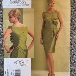 May include: A Vogue Patterns sewing pattern featuring a Bellville Sassoon design. The pattern includes a green, off-the-shoulder dress with a bow detail. The pattern cover displays a photo of the dress and the model wearing it.