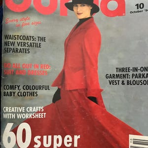 May include: A vintage Burda magazine cover featuring a woman in a red suit and black hat. The cover text includes "A World of Fashion", "60 super gift ideas", and "October '94". The magazine promotes various fashion styles and sewing patterns.