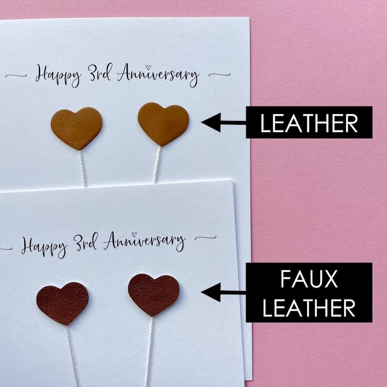May include: Two white cards with the text "Happy 3rd Anniversary" and heart-shaped decorations. The top card has two tan leather hearts, and the bottom card has two faux leather hearts in a darker brown color.