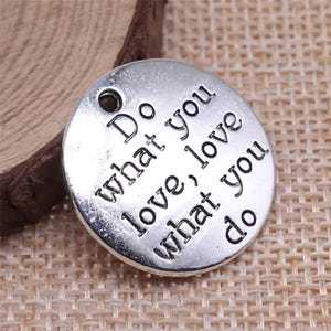 May include: Silver charm with the text "Do what you love, love what you do" engraved on it.