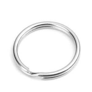 May include: A silver key ring with a smooth, circular shape.
