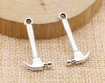 May include: Two silver-toned hammer charms with a loop at the top for attaching to jewelry or other crafts.