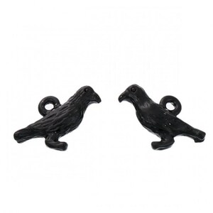 May include: Two black metal crow charms with a loop for hanging. The crows are facing to the right and have a detailed design.