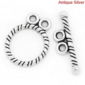 May include: Antique silver clasp with a twisted rope design and two loops on each side.
