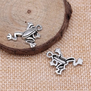 May include: Two silver frog charms with a loop for attaching to jewelry or other crafts.
