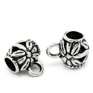 May include: Two silver metal end caps with a floral design and a loop on the side.