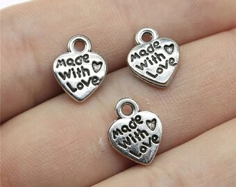 May include: Three silver heart-shaped charms with the words "Made with Love" engraved on them.