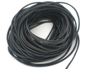 May include: A spool of black leather cord. The cord is wound tightly and is ready to be used for crafting projects.