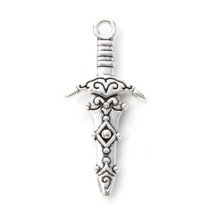 May include: Silver-toned sword charm with intricate details and a loop at the top for hanging.