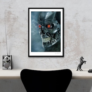 May include: A black and white illustration of a robot's face with red glowing eyes. The robot has a metallic skull with a toothy grin. The illustration is framed in a black frame with a white mat.