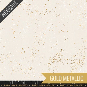 May include: White fabric with a scattered gold metallic speckles pattern. The fabric has a subtle texture and a soft, light feel. The fabric is perfect for quilting, sewing, and crafting projects.