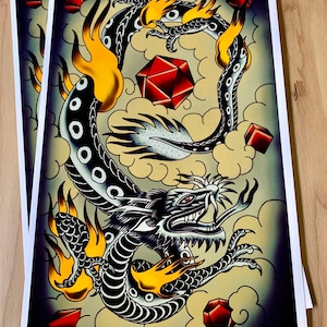 May include: A black and white dragon tattoo design with red and yellow accents. The dragon is surrounded by clouds and red gems. The dragon is in a curled position with its head facing forward.