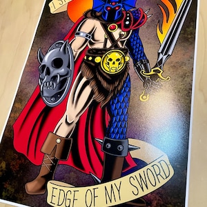 May include: A fantasy illustration of a warrior with blue scales, a red cape, and a flaming sword. The warrior is holding a shield with a skull on it. The text "I speak with the edge of my sword" is written on a banner below the warrior.