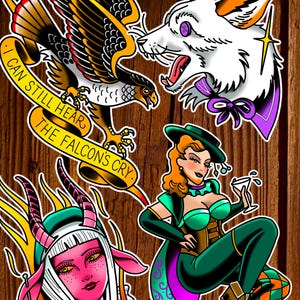 May include: A selection of tattoo-style illustrations on a wood-effect background. The designs feature an eagle with a banner saying "I can still hear the falcon's cry," a snarling white wolf, a pink demon, and a woman holding a martini glass.