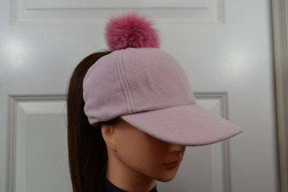 baseball cap with fur pom pom
