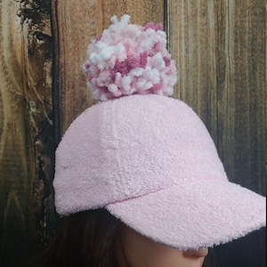 Womens baseball cap in Pink Terry Cloth with a multi colored terry pom pom has a high opening for a ponytail.