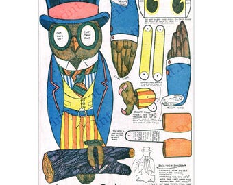 May include: Vintage paper craft kit featuring "Oscar the Owl." The owl is depicted in a blue suit, striped pants, and a top hat. Includes cut-out pieces for assembly, wings, feet, and a log base. Text includes "Cut This Out" and "Oscar the Owl."
