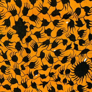 May include: Close-up of a fabric with a repeating pattern of black shapes on an orange background. The shapes resemble stylized hands or floral elements, creating a textured and dynamic design. The fabric's color palette is warm and vibrant.