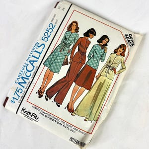 May include: Vintage McCall's 5252 sewing pattern. The pattern features illustrations of women's outfits, including a jacket, top, skirt, and pants. The pattern is for stretch knit fabrics. The package is white with text and illustrations.