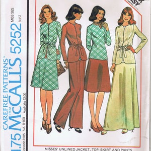 May include: Vintage McCall's 5252 sewing pattern featuring four women's outfits. The pattern includes a jacket, top, skirt, and pants. The outfits include a green plaid jacket and skirt, a rust-colored pantsuit, a green plaid top and rust skirt, and a light green jacket and skirt.
