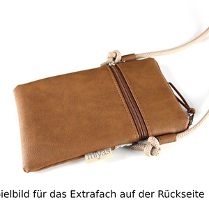 May include: A brown faux leather phone pouch with a zipper closure and a beige rope strap. The pouch has a small label that says "miyas" on the front. The image shows the back of the pouch with an extra pocket.