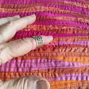 Sunrise wave landscape patchwork art quilt finger on it to show narrow strips