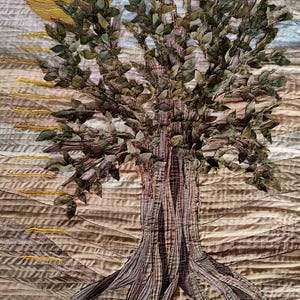 A fabric tree of life on a bron beige fabric background on a mustard sun