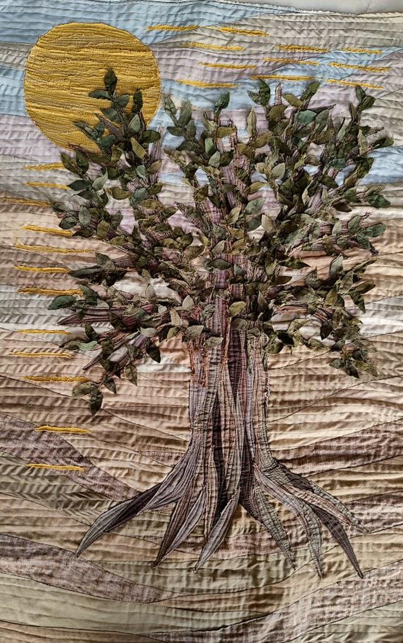 A fabric tree of life on a bron beige fabric background on a mustard sun