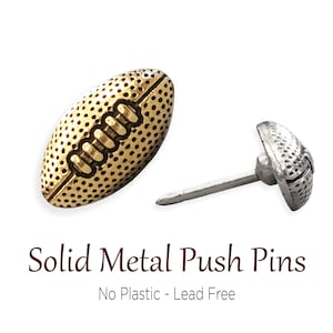 May include: Two gold metal push pins shaped like footballs. One pin is shown with the point facing up, the other is shown from the side.  Solid Metal Push Pins. No Plastic - Lead Free.