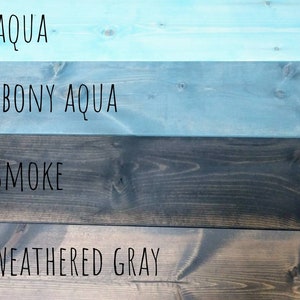May include: Four wood planks stained in different colors: aqua, ebony aqua, smoke, and weathered gray. The colors are labeled on each plank.