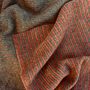 May include: Close-up of a striped fabric with a dark green and burgundy color scheme. The fabric is woven with a soft, fuzzy texture.